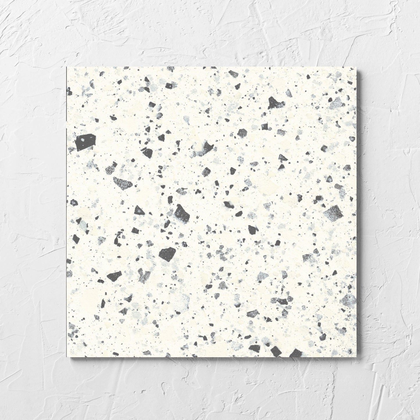 Venice White 300x300mm Matt Terrazzo Tile laid flat on a white rendered wall, showing the white matt surface