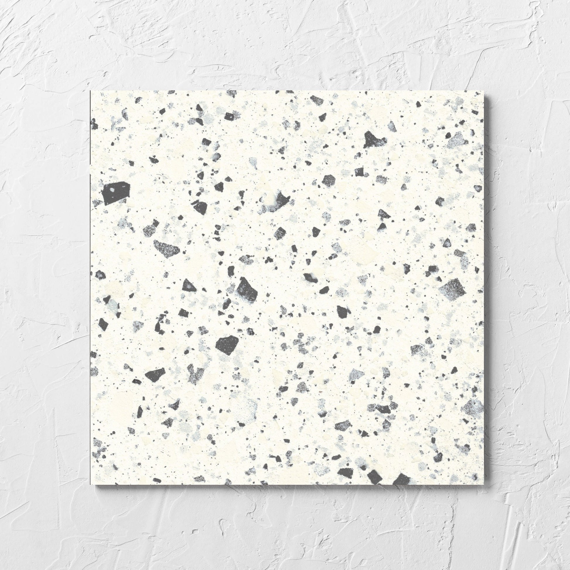Venice White 300x300mm Matt Terrazzo Tile laid flat on a white rendered wall, showing the white matt surface