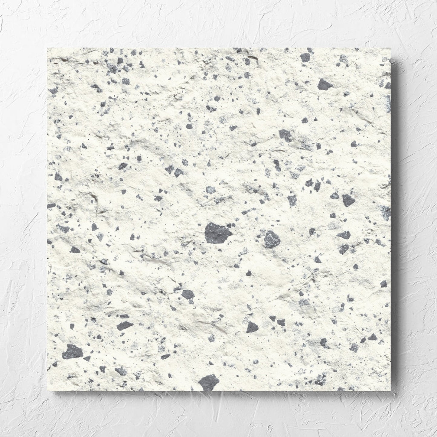 Venice White 600x600mm Matt Terrazzo External Tile laid flat on a white rendered wall, showing the white matt surface