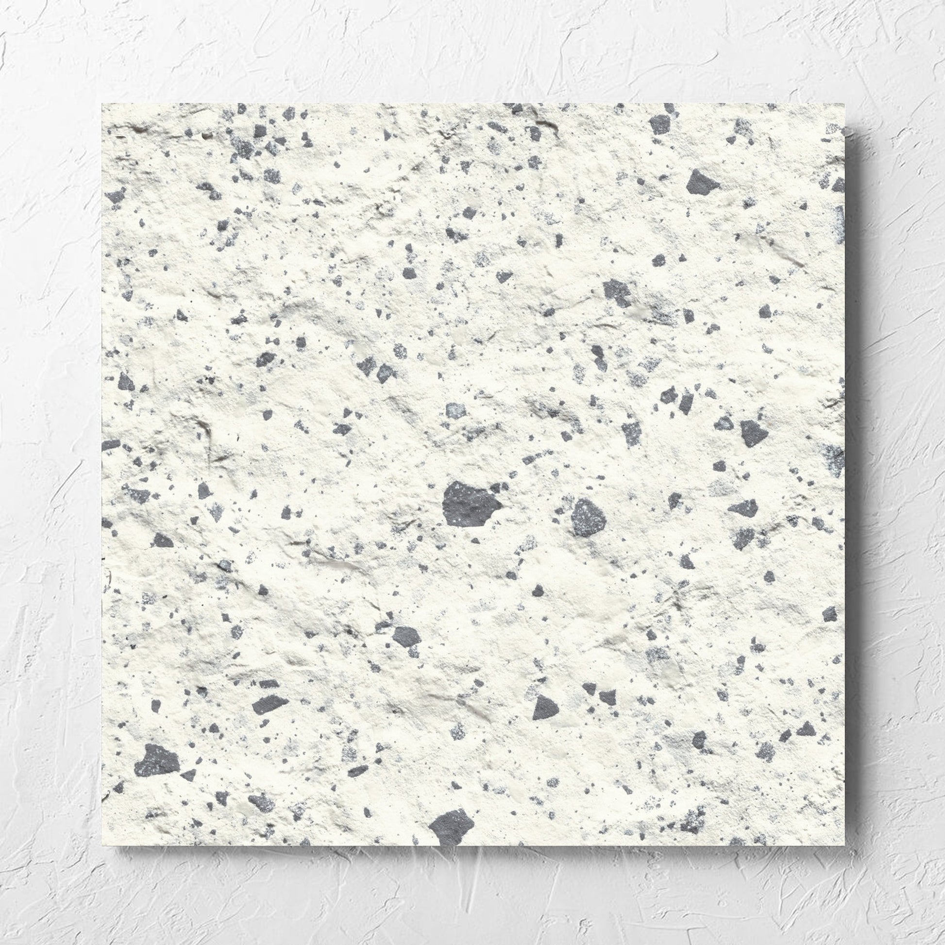 Venice White 600x600mm Matt Terrazzo External Tile laid flat on a white rendered wall, showing the white matt surface