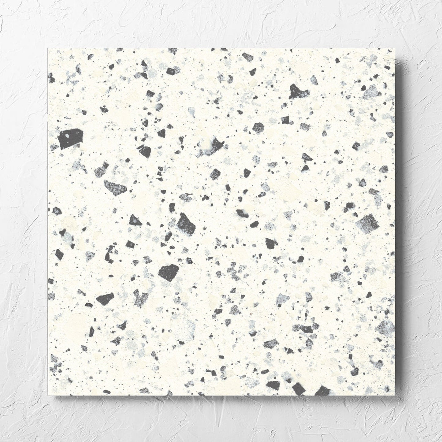 Venice White 600x600mm Matt Terrazzo Tile laid flat on a white rendered wall, showing the white matt surface