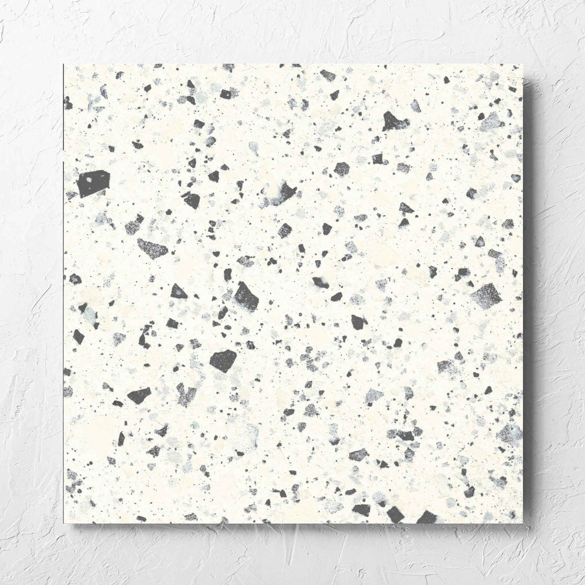 Venice White 600x600mm Matt Terrazzo Tile laid flat on a white rendered wall, showing the white matt surface