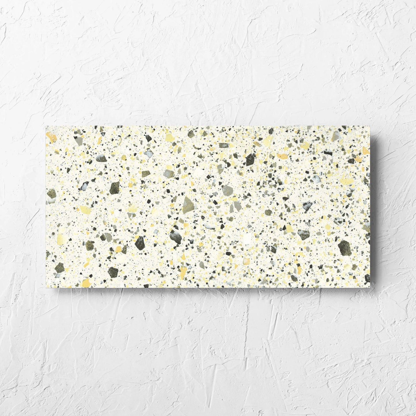 Venice Yellow 300x600mm Matt Terrazzo Tile laid flat on a white rendered wall, showing the yellow matt surface