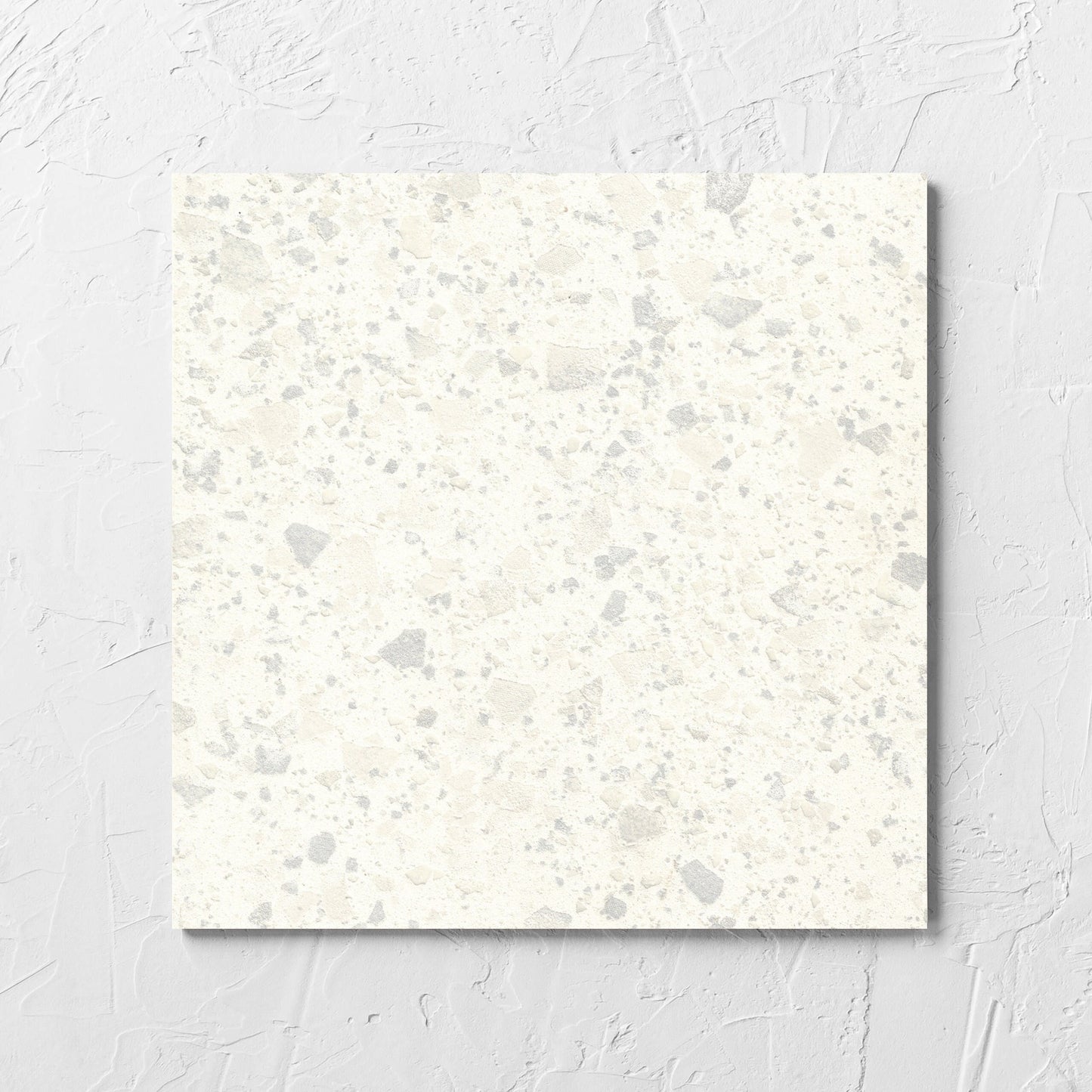 Venice Zinc 300x300mm Matt Terrazzo Tile laid flat on a white rendered wall, showing the zinc matt surface