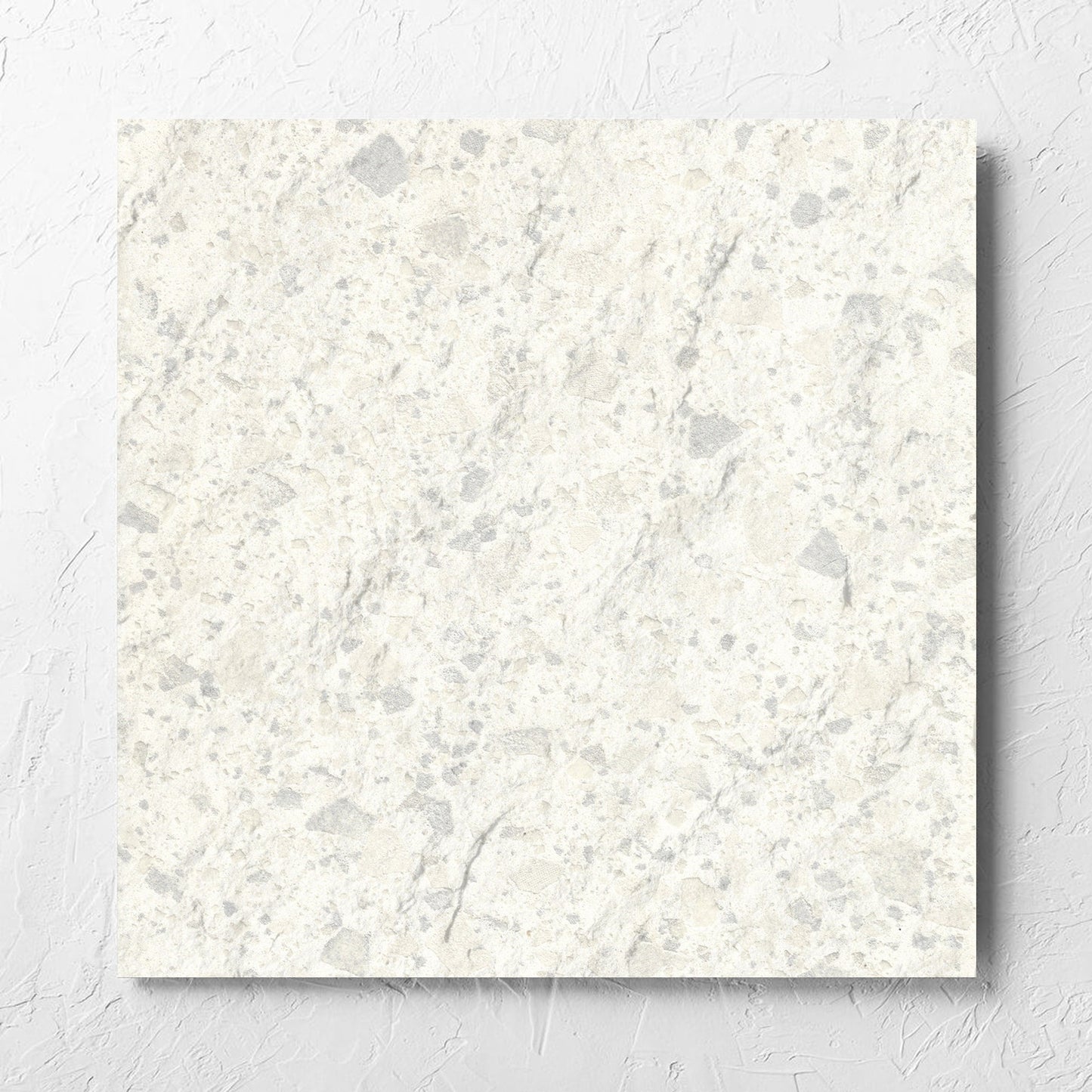 Venice Zinc 600x600mm Matt Terrazzo External Tile laid flat on a white rendered wall, showing the zinc matt surface