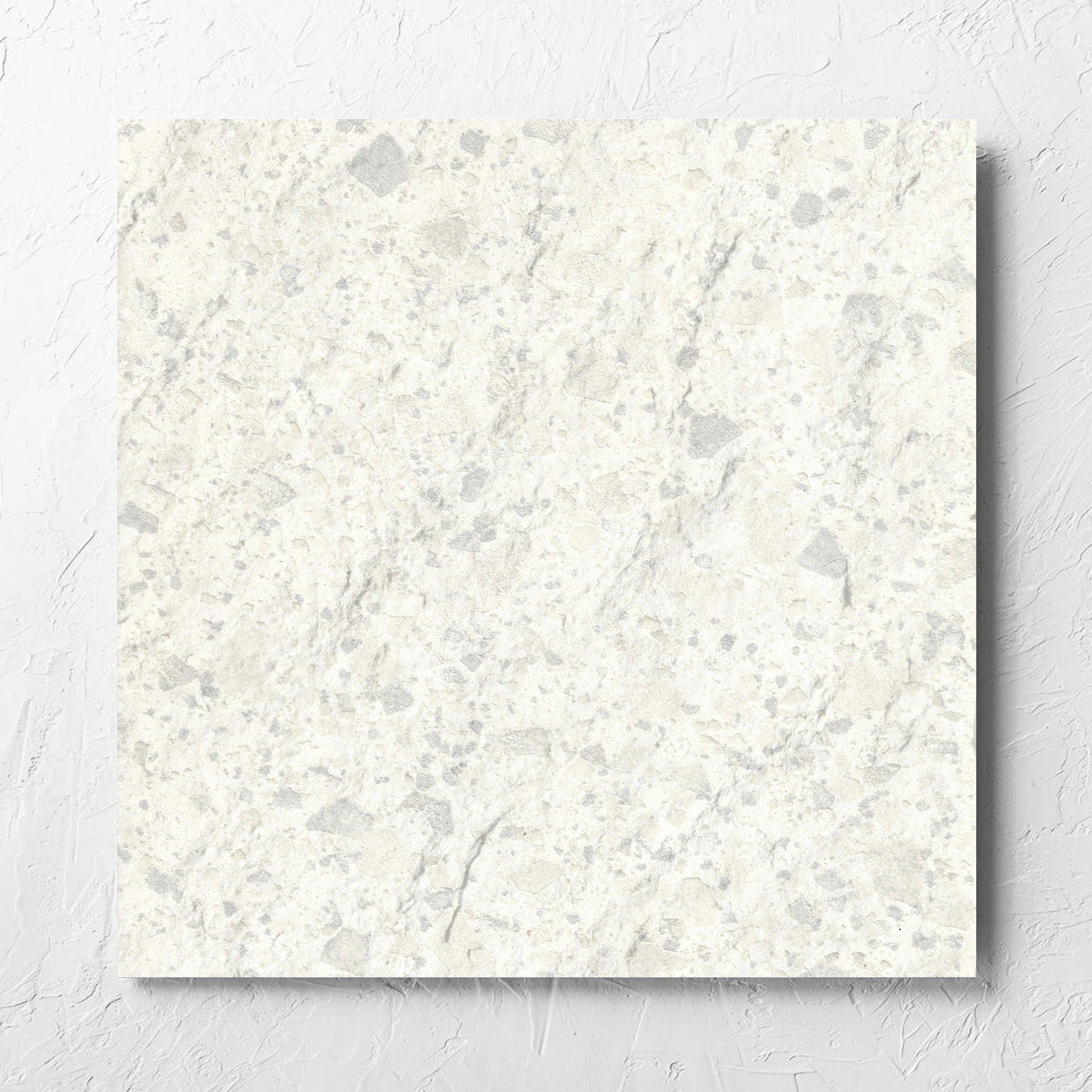 Venice Zinc 600x600mm Matt Terrazzo External Tile laid flat on a white rendered wall, showing the zinc matt surface