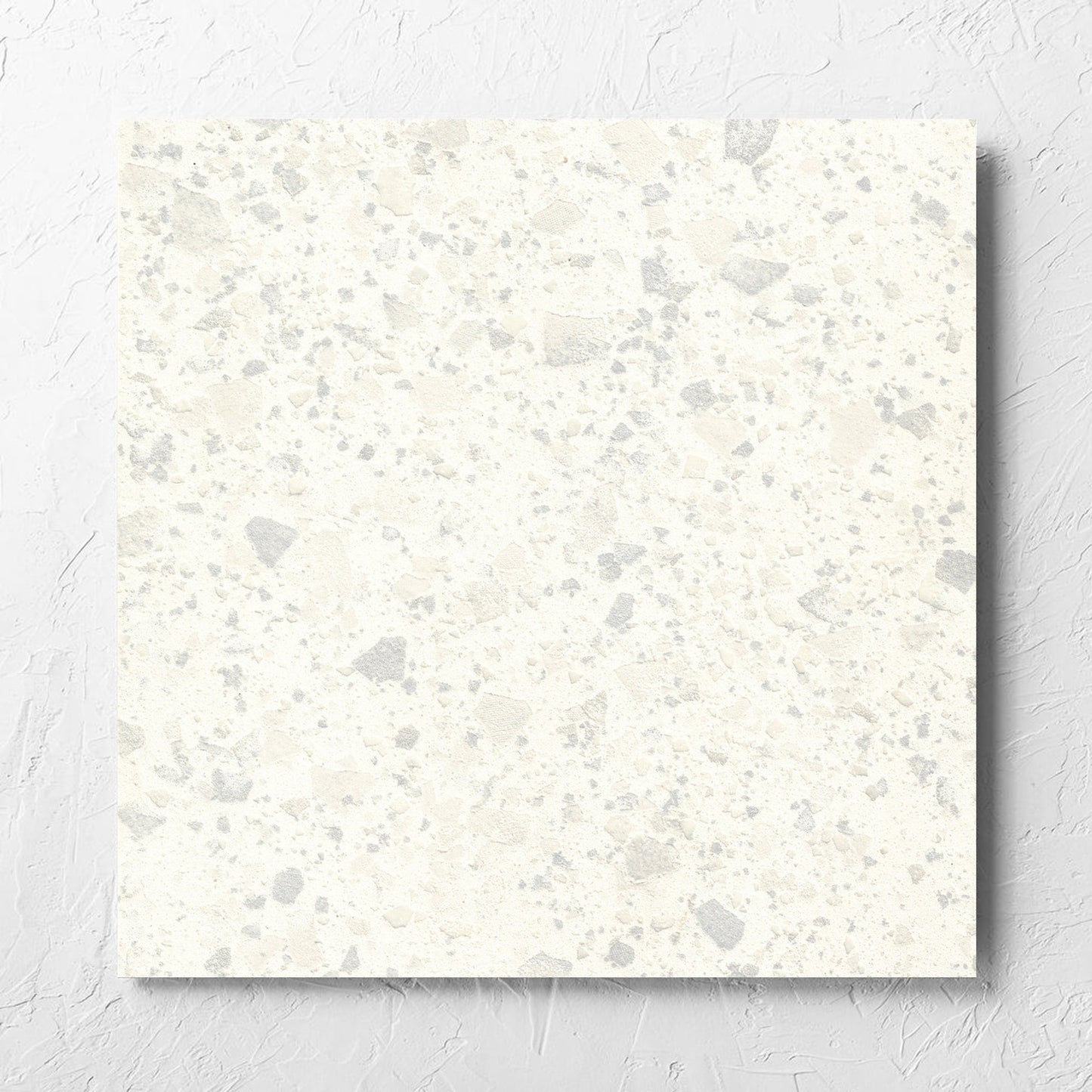 Venice Zinc 600x600mm Matt Terrazzo Tile laid flat on a white rendered wall, showing the zinc matt surface