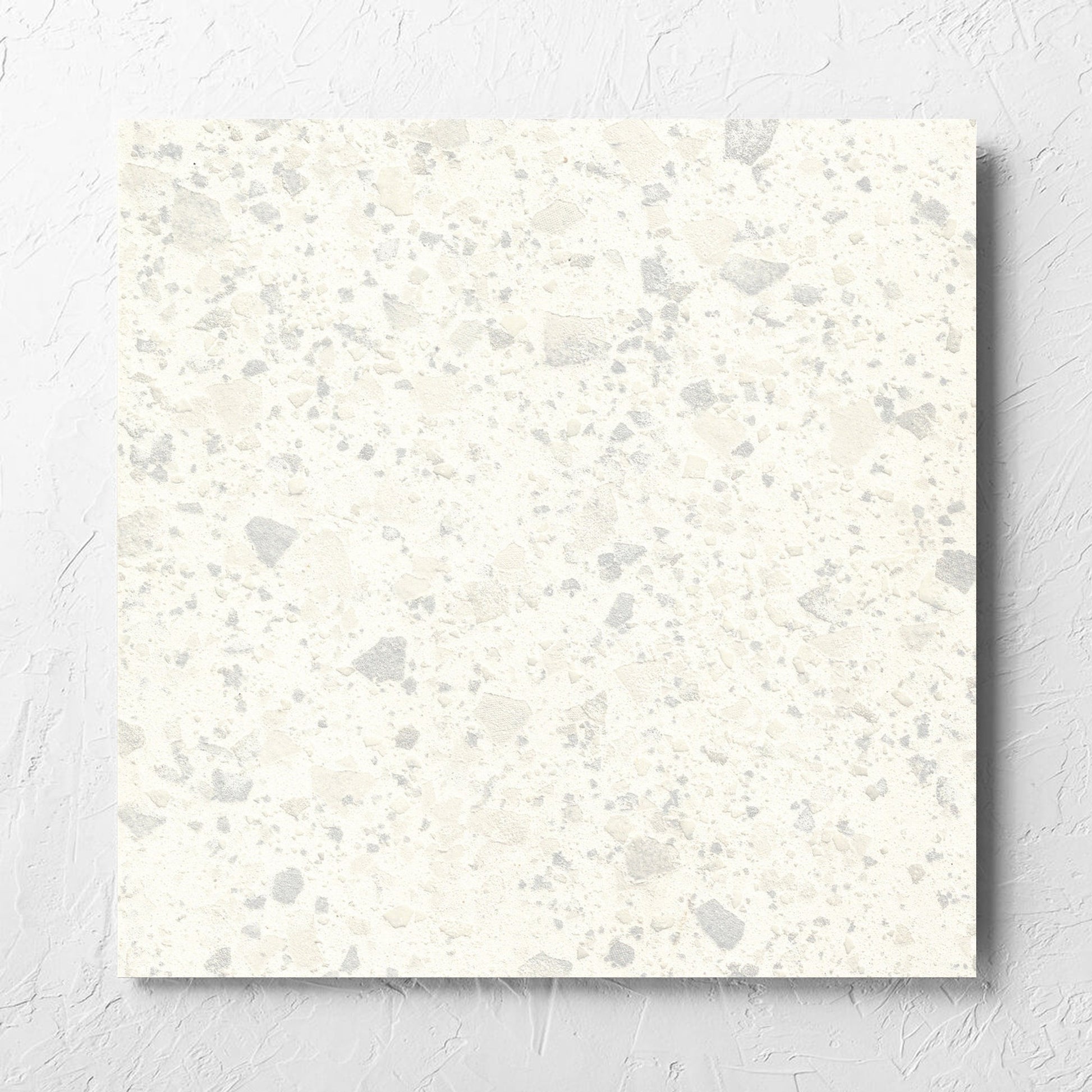 Venice Zinc 600x600mm Matt Terrazzo Tile laid flat on a white rendered wall, showing the zinc matt surface