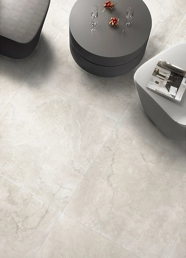 Vent Light Grey External 600x600mm porcelain floor tiles installed in a modern living room with dark round coffee table and contemporary seating.