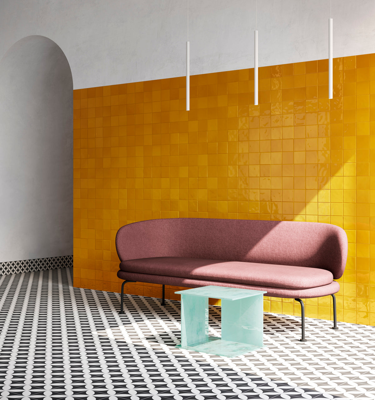 VitrA Ochre Yellow Gloss Mosaic 100x100mm tiles covering a bold feature wall behind a curved mauve sofa, styled with a glass side table and geometric floor tiles.