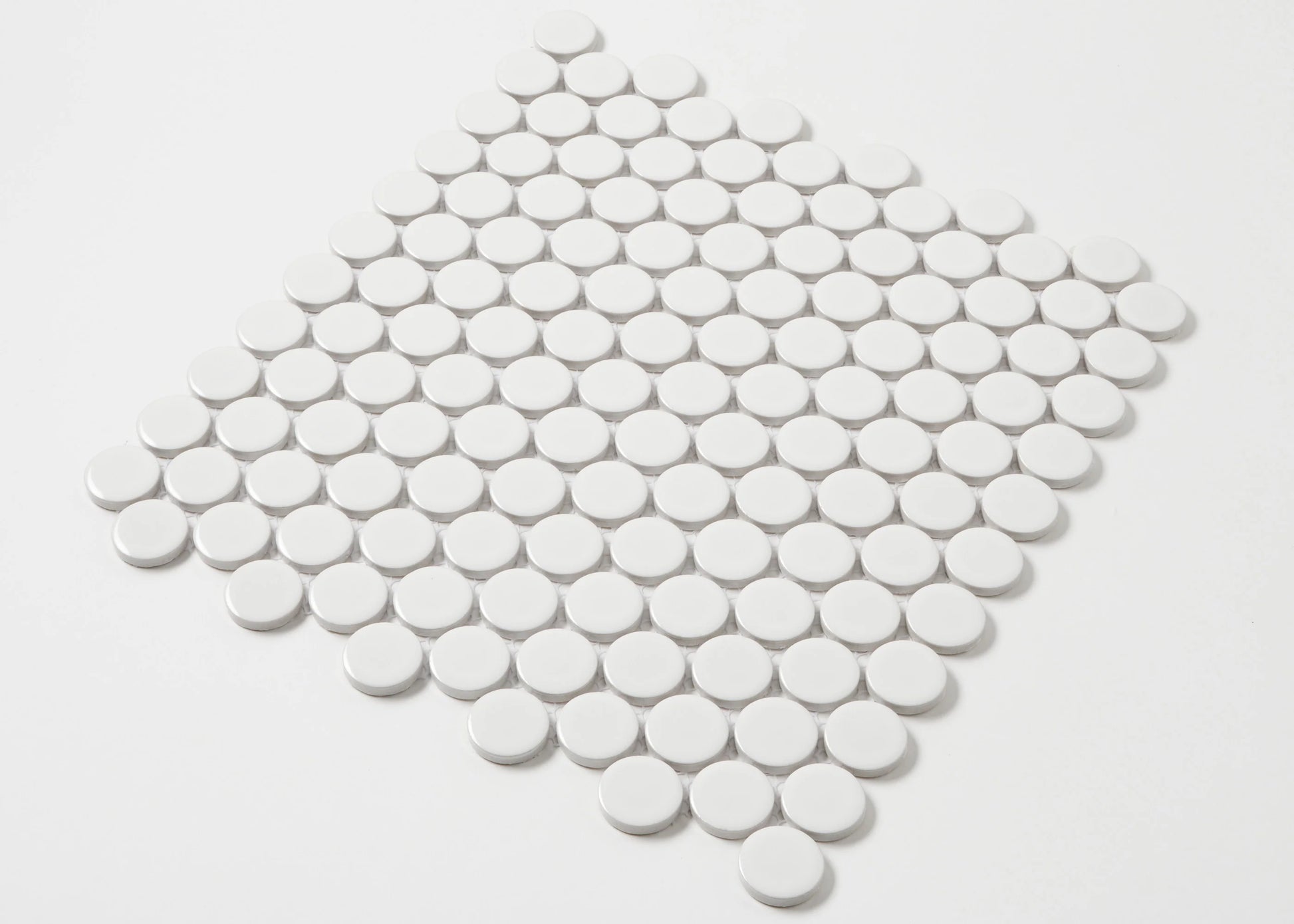 White Gloss Glazed Porcelain Penny Round 28mm Diameter tiles arranged in a diamond-shaped mosaic sheet showing their circular glossy white finish.