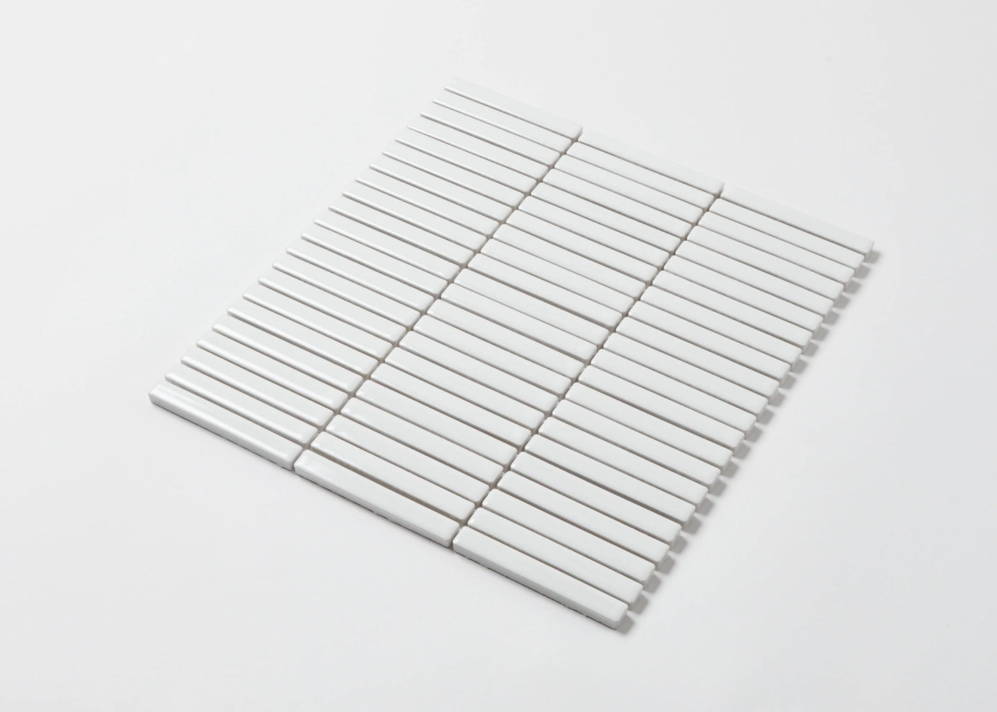 A single mesh-backed sheet of White Gloss Porcelain KitKat 12x92mm tiles arranged in parallel rows on a white background.