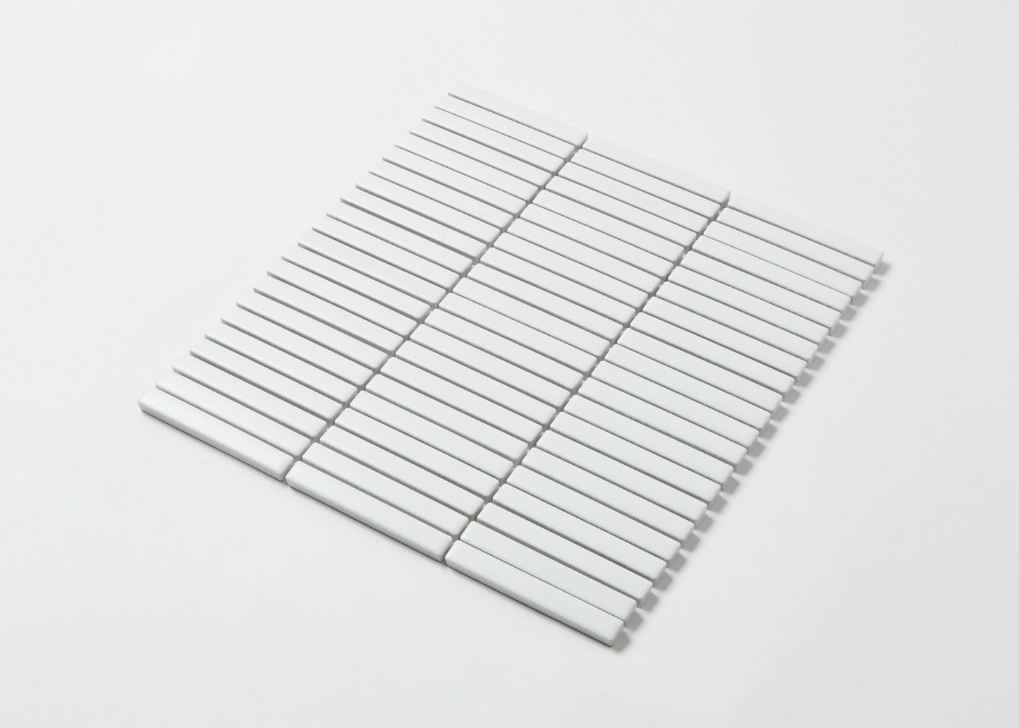 Pack shot of White Matt Kitkat Straight Bone Pattern 12X92mm tiles arranged in a straight stacked grid layout showing the slim rectangular matte white finish.