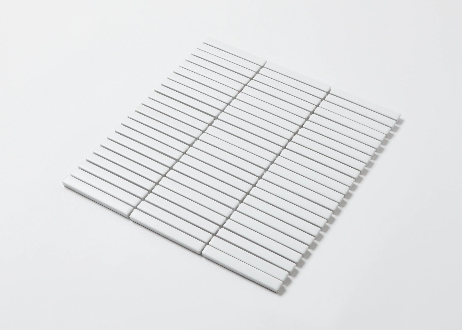 Pack shot of White Matt Kitkat Straight Bone Pattern 12X92mm tiles arranged in a straight stacked grid layout showing the slim rectangular matte white finish.