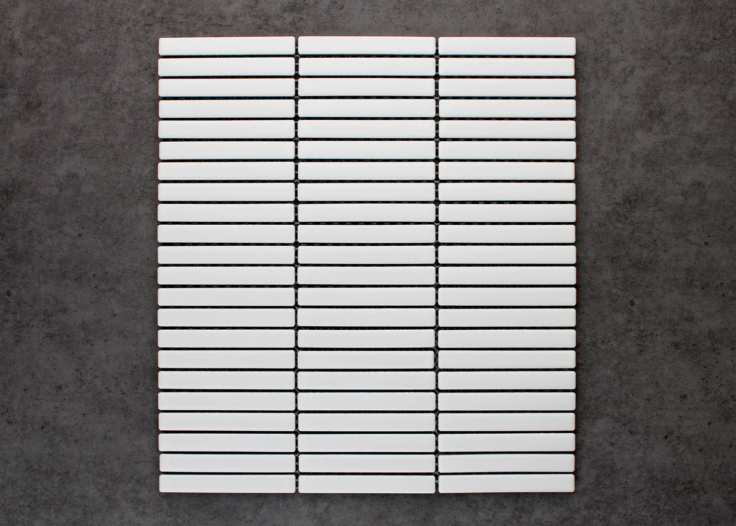 A flat-lay pack shot of White Matt Kitkat Straight Bone Pattern 12X92mm tiles arranged in a straight stacked grid of slim white rectangular bars with dark grout lines.