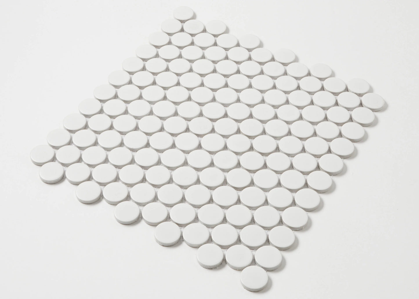 White Matte Glazed Porcelain Penny Round 28mm Diameter tiles arranged in a diamond-shaped mosaic sheet, showing matte white circular tiles with grey grout lines.