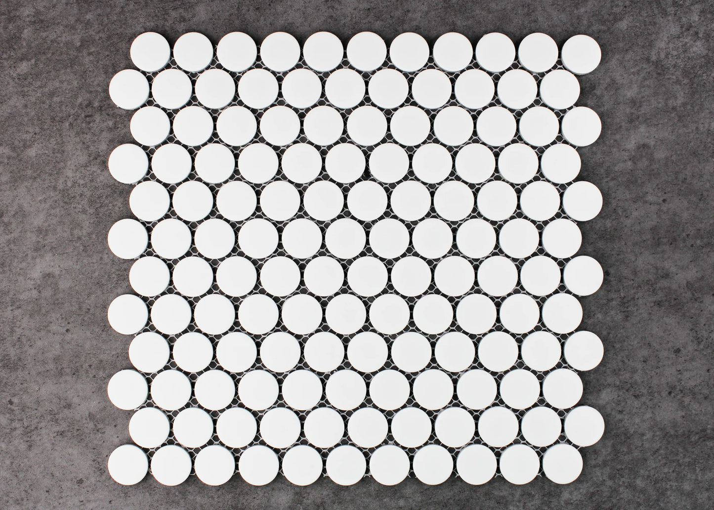 A flat-lay pack shot of White Matte Glazed Porcelain Penny Round 28mm Diameter mosaic sheet showing uniform circular white matte tiles arranged in an offset pattern on mesh backing.