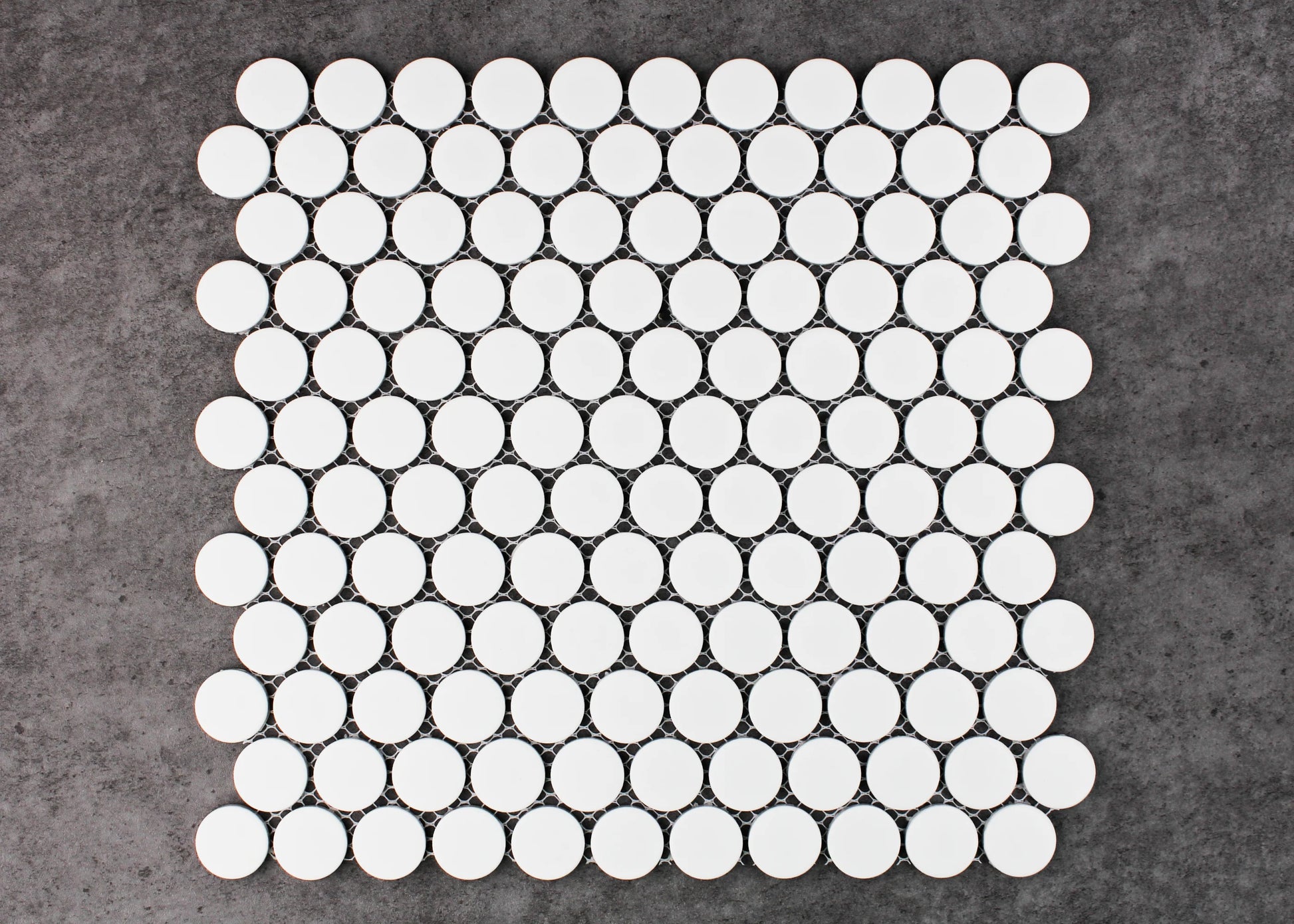 A flat-lay pack shot of White Matte Glazed Porcelain Penny Round 28mm Diameter mosaic sheet showing uniform circular white matte tiles arranged in an offset pattern on mesh backing.