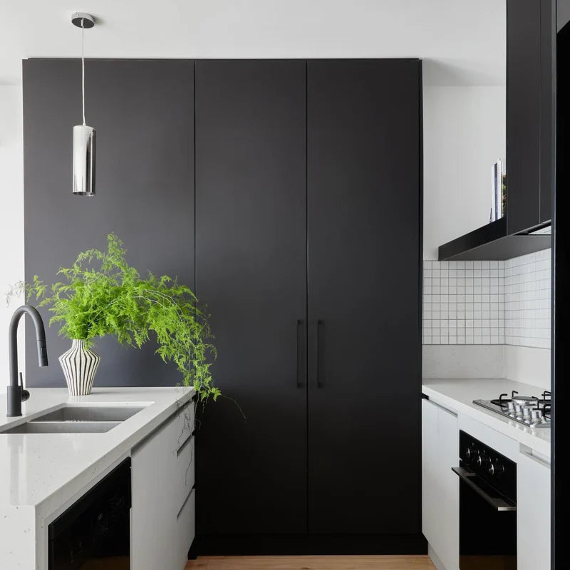 White Matte Porcelain Glazed 48x48mm Square tiles on a kitchen splashback with black cabinetry, gas cooktop, and chrome pendant light.
