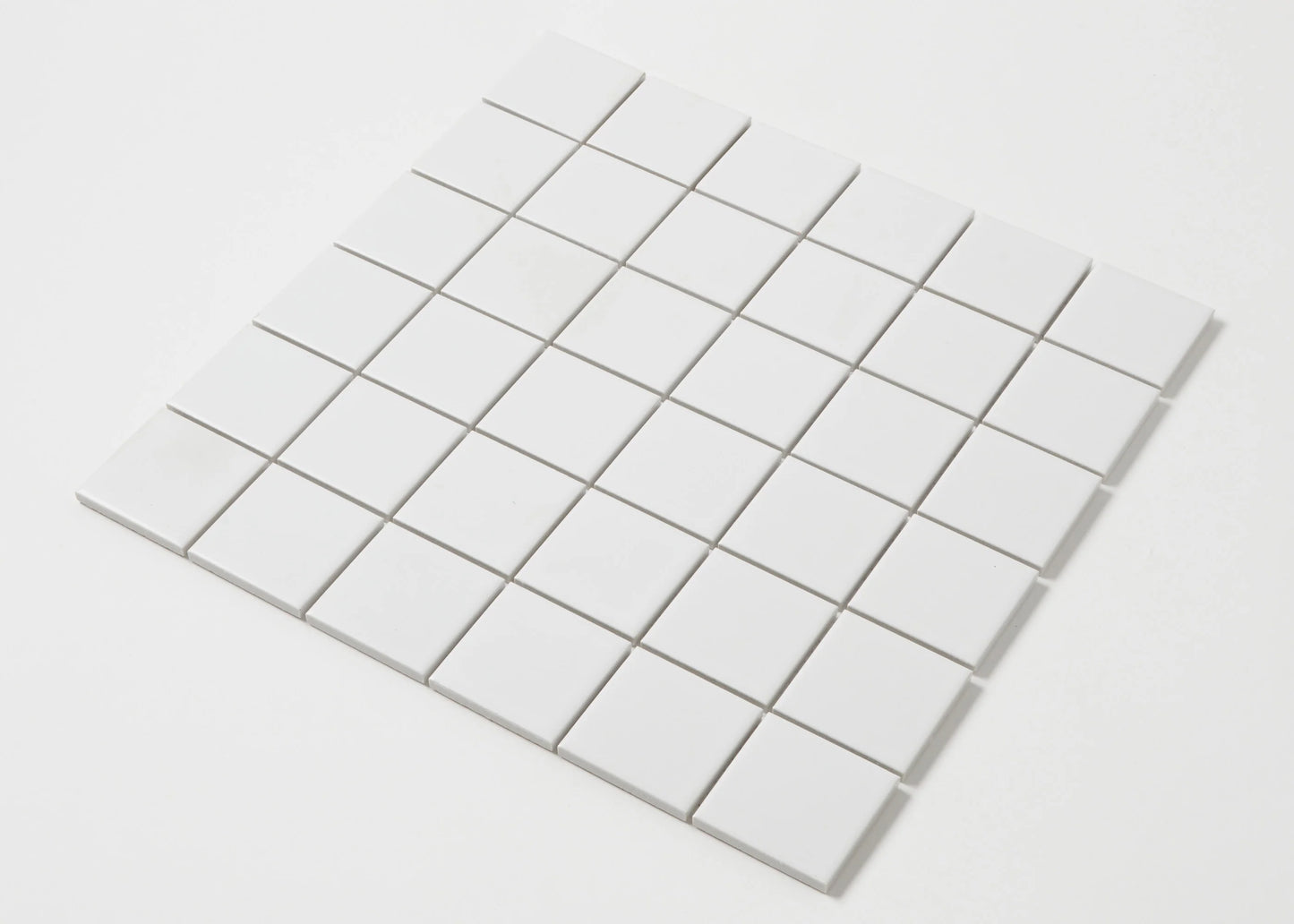 Pack shot of White Matte Porcelain Glazed 48x48mm Square tiles arranged in a 6x6 grid sheet showing a smooth matte white finish and uniform square format.