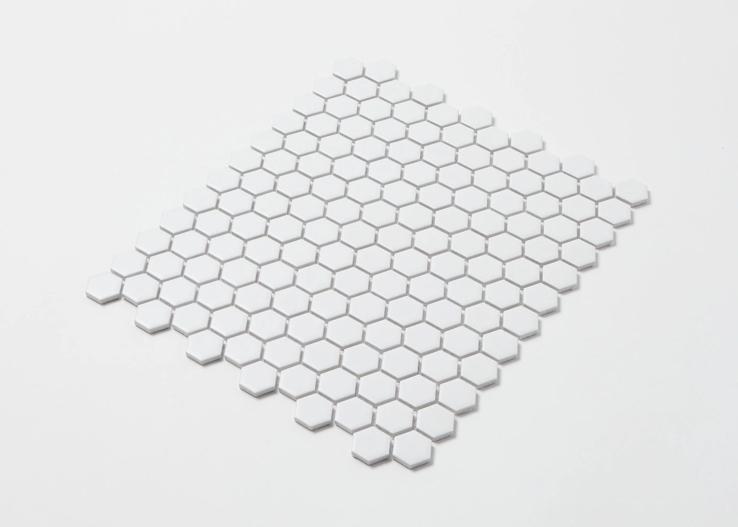 Pack shot of White Matte Porcelain Glazed Hexagon 23mm mosaic tile sheet arranged in a diamond layout showing uniform matte white finish and small hexagonal pattern.