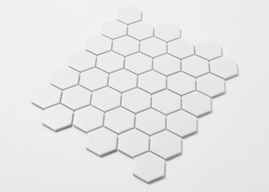 Pack shot of White Matte Porcelain Glazed Hexagon 51x59mm tiles arranged in a honeycomb mosaic pattern against a white background.