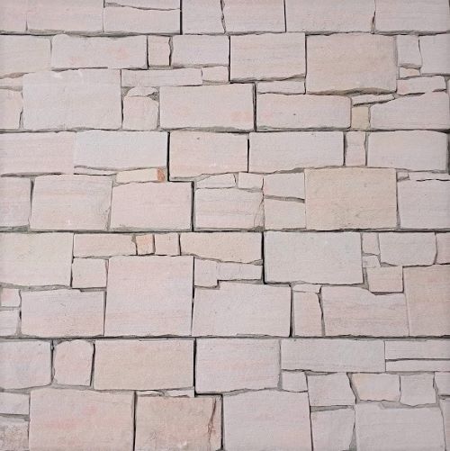 Close-up texture shot of White Sandstone Z Panel Interlock 200x600mm showing natural irregular stone blocks in soft cream and blush tones with subtle variation.