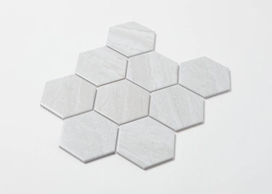 Pack shot of Wooden Grey Matte Porcelain Glazed Hexagon 95x110mm tiles arranged in a honeycomb cluster, showing subtle grey veining and matte finish on a white background.