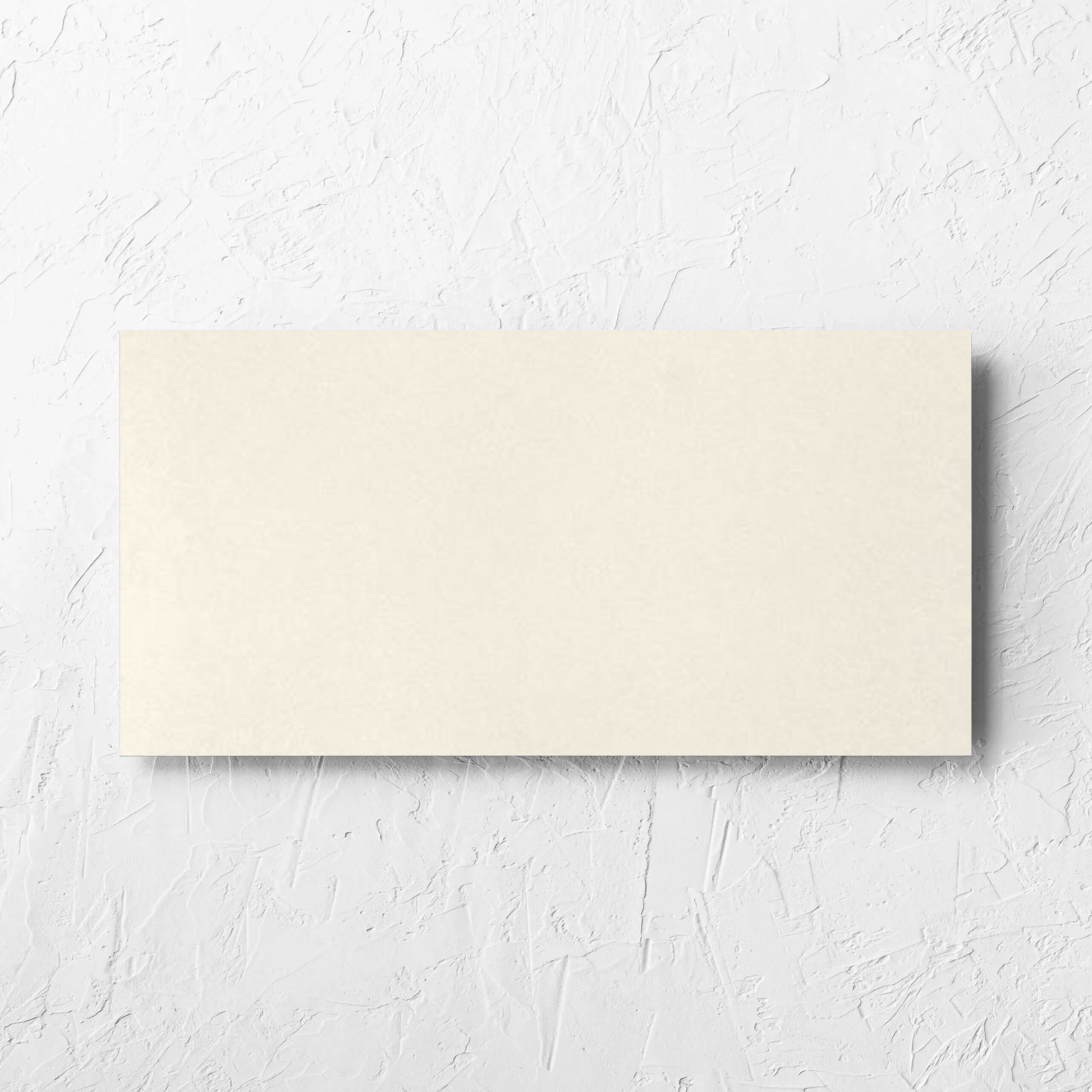 Yarra Soft Beige Satin 300x600mm tile laid flat on a white rendered wall, showing the tile surface