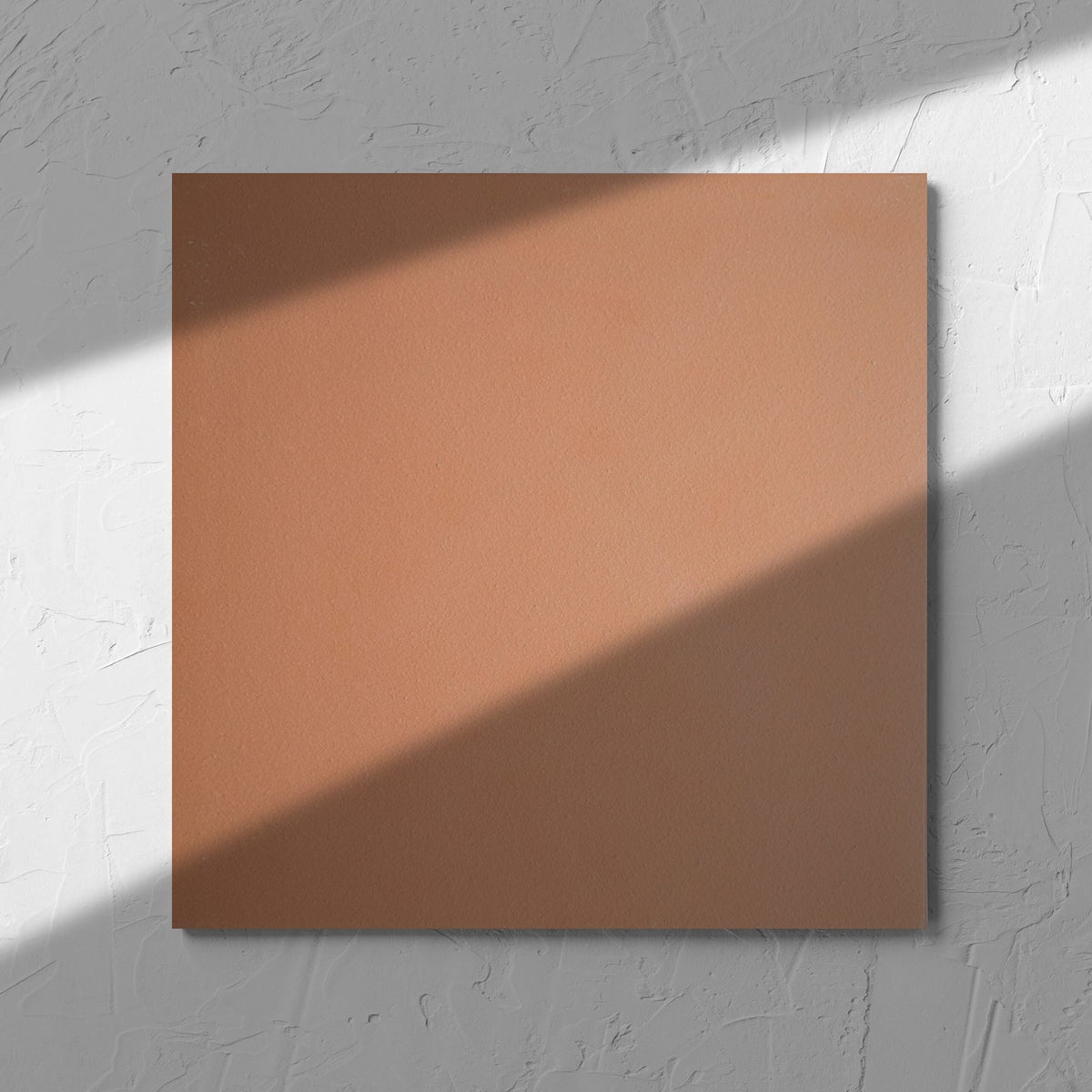 Yulara Terracotta 300x300mm tile in soft natural window light, showing the tile surface