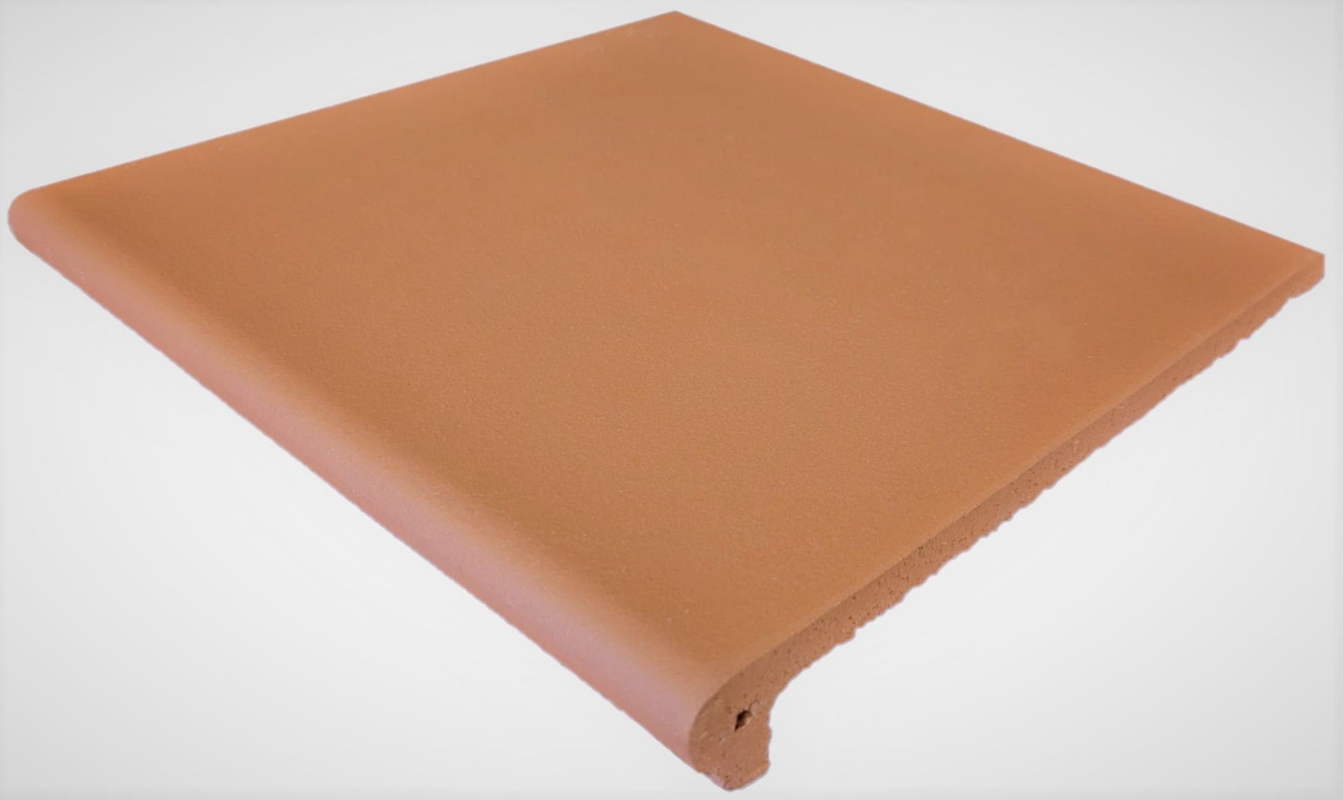 Yulara Terracotta Step Nose 300x300mm tile shown as a single packshot with a smooth matte terracotta finish and rounded bullnose front edge.
